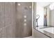 Bathroom featuring an elegantly tiled shower at 5807 Thoreau Pl, Lithia, FL 33547