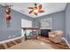 Bedroom with hardwood floors, chair, ceiling fan, natural light and a craftsman style industrial desk and rolling stool at 5807 Thoreau Pl, Lithia, FL 33547