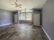 Spacious bedroom features stone floors, closet, large window, light gray walls, and curtains at 5807 Thoreau Pl, Lithia, FL 33547
