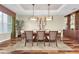 Elegant dining room featuring modern lighting, stylish decor, and a large window to let in natural light at 5807 Thoreau Pl, Lithia, FL 33547