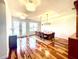 Bright dining room featuring a modern chandelier and sleek hardwood floors at 5807 Thoreau Pl, Lithia, FL 33547