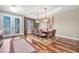 Elegant dining room featuring modern lighting, stylish decor, and a large window to let in natural light at 5807 Thoreau Pl, Lithia, FL 33547