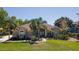 Charming single-story home featuring lush landscaping, a well-manicured lawn, and a symmetrical facade at 5807 Thoreau Pl, Lithia, FL 33547