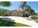This property features a spacious three-car garage and a long driveway perfect for extra parking at 5807 Thoreau Pl, Lithia, FL 33547