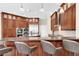 Kitchen features a large breakfast bar with pendant lighting and stone countertops at 5807 Thoreau Pl, Lithia, FL 33547