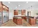 Open kitchen featuring a large island, custom cabinets and stainless steel appliances at 5807 Thoreau Pl, Lithia, FL 33547