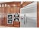 Close up view of the gourmet kitchen featuring stainless steel appliances and custom cabinets at 5807 Thoreau Pl, Lithia, FL 33547