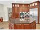 Gourmet kitchen with custom wood cabinets, stone counters, and stainless steel appliances at 5807 Thoreau Pl, Lithia, FL 33547