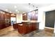 Spacious kitchen with dark wood cabinetry and stone tile floors at 5807 Thoreau Pl, Lithia, FL 33547