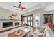 A living room with a decorative fireplace, and plush seating that leads to the outdoor pool area through french doors at 5807 Thoreau Pl, Lithia, FL 33547