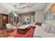 Elegant living room featuring modern lighting, stylish decor, and a wall of windows offering stunning outdoor views at 5807 Thoreau Pl, Lithia, FL 33547