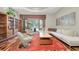 Elegant living room featuring modern lighting, stylish decor, and a wall of windows offering stunning outdoor views at 5807 Thoreau Pl, Lithia, FL 33547
