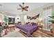 Spacious main bedroom with a ceiling fan, wood floors, and comfortable seating at 5807 Thoreau Pl, Lithia, FL 33547