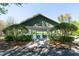 Community picnic pavilion with picnic tables, green trim and white supports flanked by neatly trimmed hedges and trees at 5807 Thoreau Pl, Lithia, FL 33547