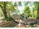 Community playground with mature trees providing shade and green and red play equipment at 5807 Thoreau Pl, Lithia, FL 33547