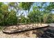 Community playground with swings and monkey bars is surrounded by lush trees and green space at 5807 Thoreau Pl, Lithia, FL 33547