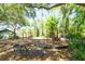 Community playground with mature trees providing shade and a bench for parents to relax at 5807 Thoreau Pl, Lithia, FL 33547