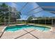 Inviting screened-in pool with brick paver deck and mature landscaping at 5807 Thoreau Pl, Lithia, FL 33547