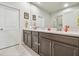 Bright bathroom with dual sinks, granite countertops, and contemporary cabinets at 5833 Grand Sonata Ave, Lutz, FL 33558