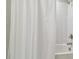 Bright bathroom featuring a shower and tub combination with a fresh white curtain at 5833 Grand Sonata Ave, Lutz, FL 33558