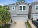 Two-story home with a well-kept exterior, complemented by green landscaping and an attached garage at 5833 Grand Sonata Ave, Lutz, FL 33558