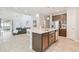 Open concept kitchen featuring a kitchen island, tile floors, and a view into the living room at 5833 Grand Sonata Ave, Lutz, FL 33558