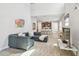 Open-concept living area with a large sectional sofa, wood-look tile flooring, and kitchen view at 5833 Grand Sonata Ave, Lutz, FL 33558