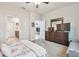 Cozy main bedroom featuring a plush bed, dresser with TV, and ensuite bathroom access at 5833 Grand Sonata Ave, Lutz, FL 33558