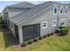 Exterior rear view of the house showing the screened patio, yard, and landscaping at 5833 Grand Sonata Ave, Lutz, FL 33558