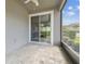 View of a screened-in patio with brick flooring, a ceiling fan, and a sliding glass door at 5833 Grand Sonata Ave, Lutz, FL 33558