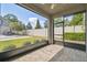 View from screened patio overlooking the backyard with greenery and a privacy fence at 5833 Grand Sonata Ave, Lutz, FL 33558