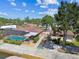 Aerial view of a private pool, landscaped backyard, and screened in patio in a waterfront single Gathering home at 6732 Udell Ln, Hudson, FL 34667
