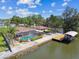 An overhead shot showing the backyard pool, dock, and boat lift on waterfront property at 6732 Udell Ln, Hudson, FL 34667