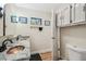 This well-lit bathroom has a double vanity with granite counters, updated hardware, and stylish framed art at 6732 Udell Ln, Hudson, FL 34667