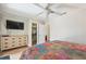 This primary bedroom features a ceiling fan, dresser, and a walk-in closet for ample storage at 6732 Udell Ln, Hudson, FL 34667