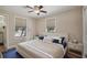 Cozy bedroom with wood floors, dual windows, and stylish nautical-themed décor at 6732 Udell Ln, Hudson, FL 34667