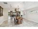 Bright dining room boasts tile flooring, a chandelier, and views of the adjacent living area and outdoor pool at 6732 Udell Ln, Hudson, FL 34667