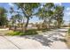 Charming, single-story home featuring a brick fence, mature trees, and a well-manicured front lawn on a bright, sunny day at 6732 Udell Ln, Hudson, FL 34667