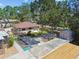 Exterior aerial showcasing the house with a shed in the backyard with mature trees at 6732 Udell Ln, Hudson, FL 34667