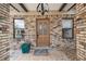 Welcoming front porch with decorative brickwork, a new door, and a colorful welcome mat at 6732 Udell Ln, Hudson, FL 34667