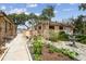 Landscaped garden with decorative elements, enhancing the home's curb appeal at 6732 Udell Ln, Hudson, FL 34667