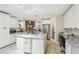 Bright kitchen features white cabinetry, stainless steel appliances, and a spacious center island at 6732 Udell Ln, Hudson, FL 34667