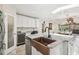 Kitchen and breakfast nook features granite countertops, stainless appliances, and ample cabinet space at 6732 Udell Ln, Hudson, FL 34667