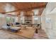 Relaxing living room showcases a brick fireplace, wooden ceiling, and access to an outdoor patio at 6732 Udell Ln, Hudson, FL 34667