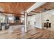 Wood-paneled living room features a brick fireplace, and seamless flow into the dining area at 6732 Udell Ln, Hudson, FL 34667