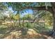 Relax in your backyard with the included swing and garden area and white picket fence at 7157 Quail Hollow Blvd, Wesley Chapel, FL 33544