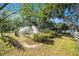 Spacious backyard showcasing various outbuildings, garden area and lush greenery at 7157 Quail Hollow Blvd, Wesley Chapel, FL 33544