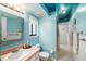 Well-lit bathroom featuring beadboard paneling, updated fixtures, and coordinated blue color scheme at 7157 Quail Hollow Blvd, Wesley Chapel, FL 33544