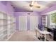 Bright bedroom with high ceilings, fan, built in shelving, and closet space at 7157 Quail Hollow Blvd, Wesley Chapel, FL 33544