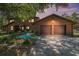 Charming log-cabin-style home with a two-car garage and well-manicured landscaping at 7157 Quail Hollow Blvd, Wesley Chapel, FL 33544
